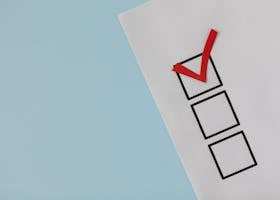 A simple white paper checklist with one red checkmark, ideal for concepts like completion or approval.